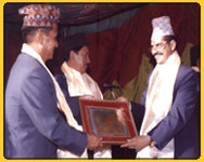 Rajan receiving an appriciation letter from Tourism minister