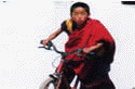 Bhutan monk at bycycle